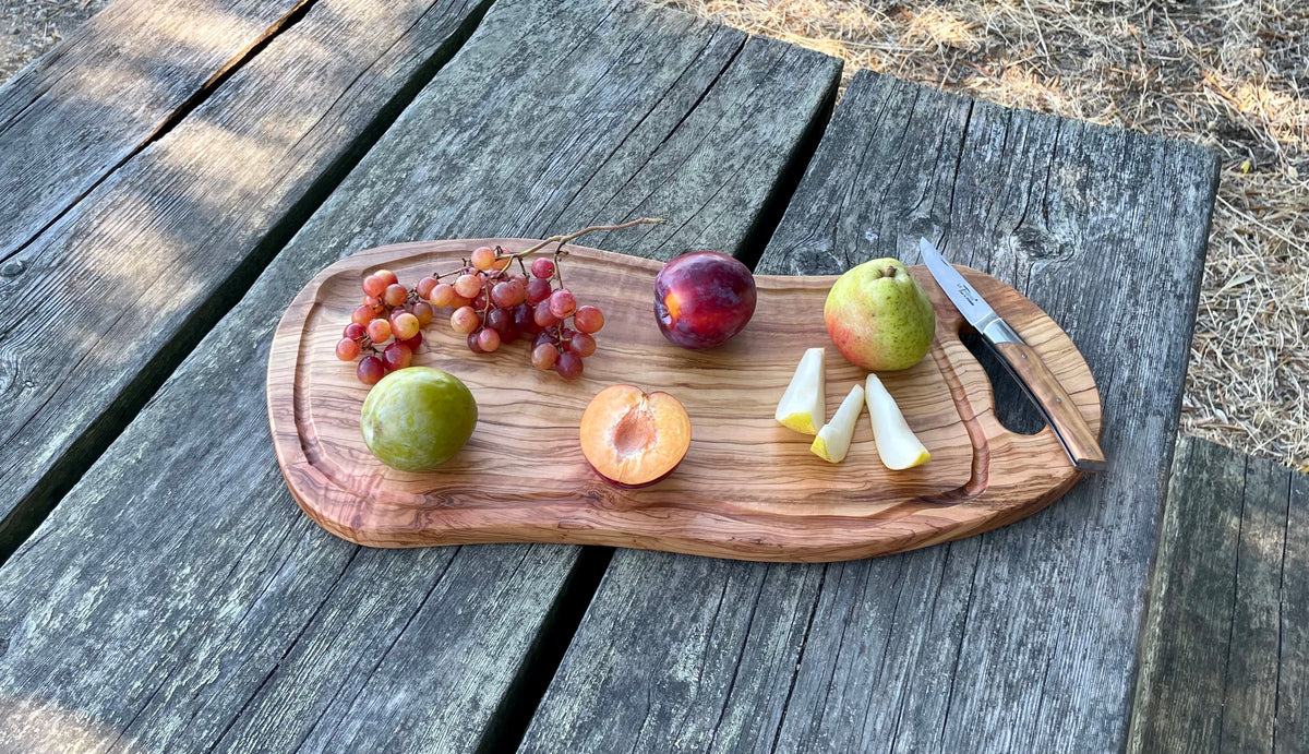 Olive wood cutting and serving board with handle and juice groove