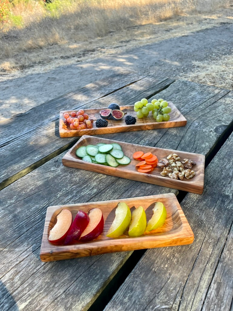 Handmade olive wood serving trays with appetizers and fruit