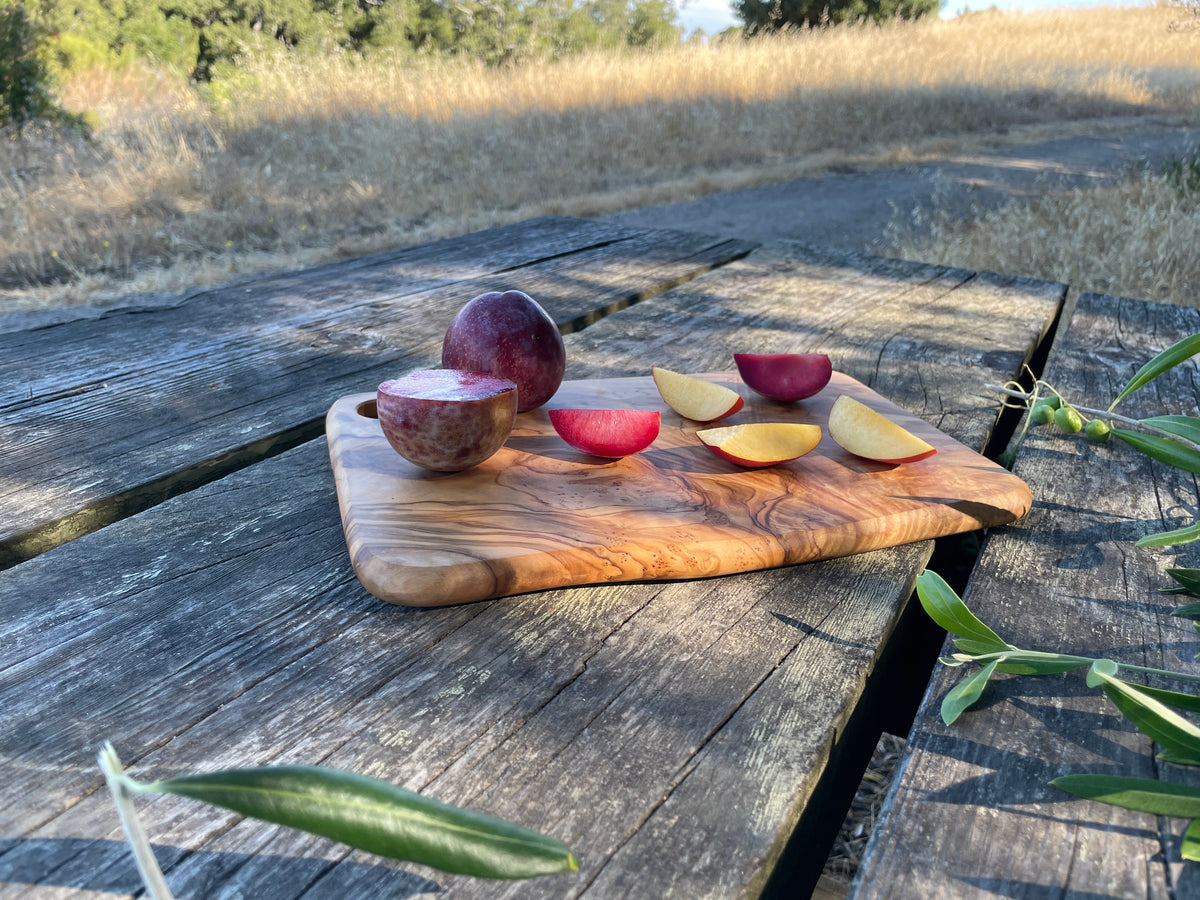 Handmade olive wood cheese and charcuterie board with grain