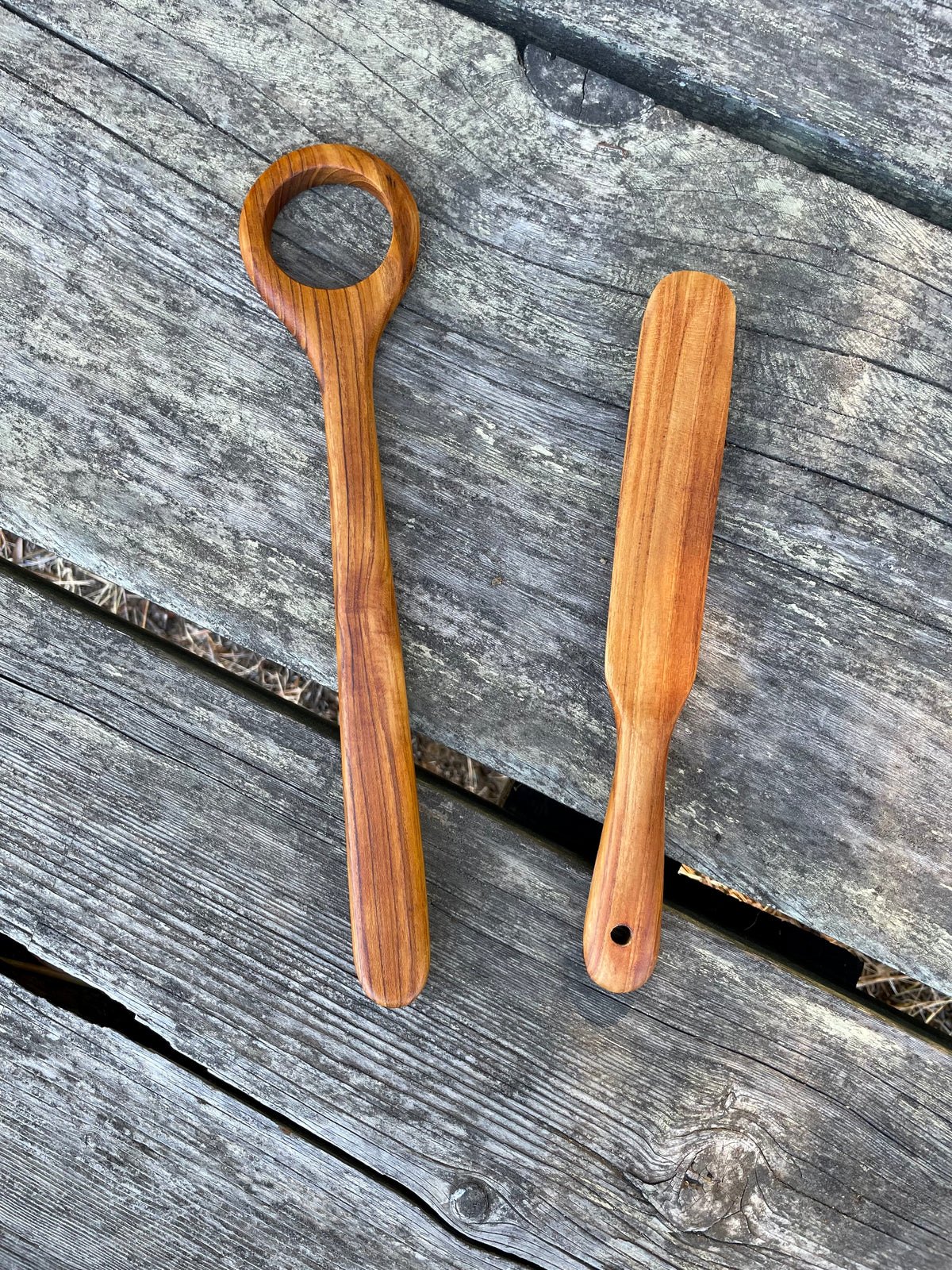 Handmade teak spurtle and Danish dough whisk on weathered wood