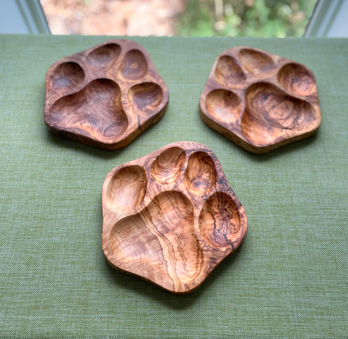 Handmade olive wood dog paw snack dishes with natural grain